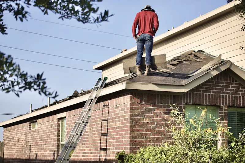Professional roofer working on a residential roof in Williamsville